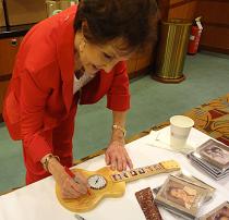 Signing a unique guitar clock made by Joe with artists represented from the 2012 Opry Cruise
